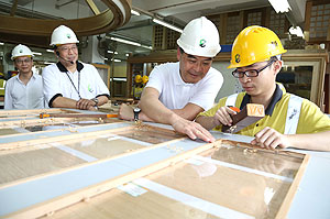 Mr Leung visits a carpentry and joinery workshop and chats with trainees to learn about their course.