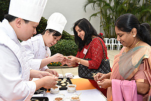 Members of a Hong Kong team of chefs showing the guests how to make local snacks.