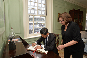 Signing a guest book when visiting Harvard University.