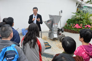 The Chief Executive presents a wood chipper to visitors during the sneak preview.