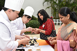 Members of a Hong Kong team of chefs showing the guests how to make local snacks. Members of a Hong Kong team of chefs showing the guests how to make local snacks.