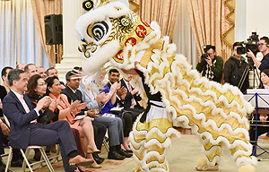 The energetic performance by the winning team of a high school lion dance competition adds festive atmosphere to the party.